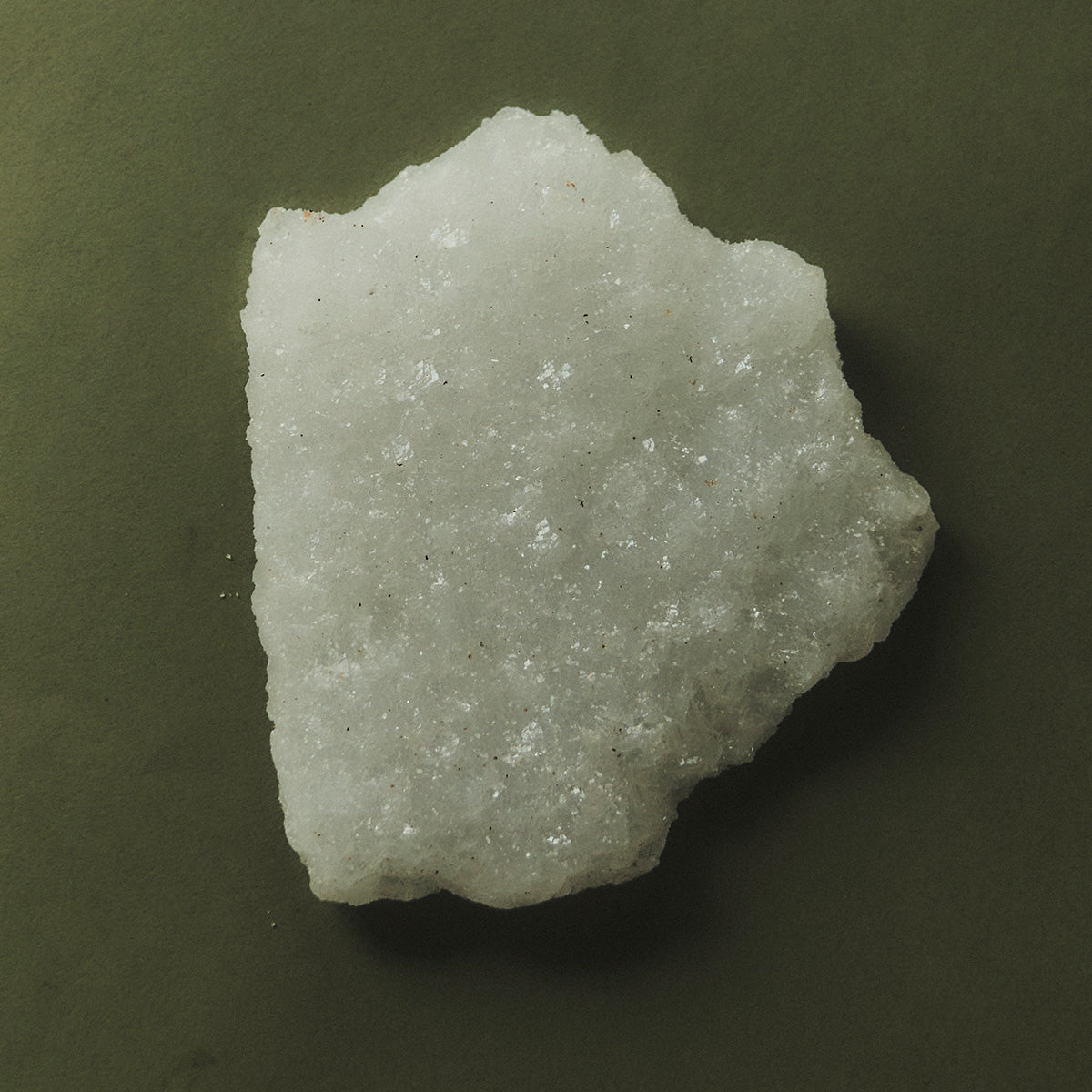 White crystal on green surface