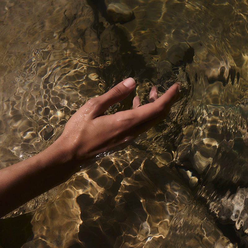 Hand touching water
