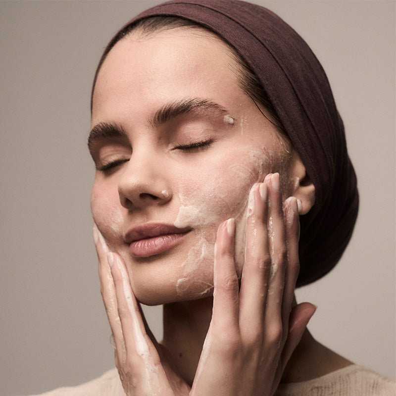 Rising Tides Facial Cleanser on woman's face